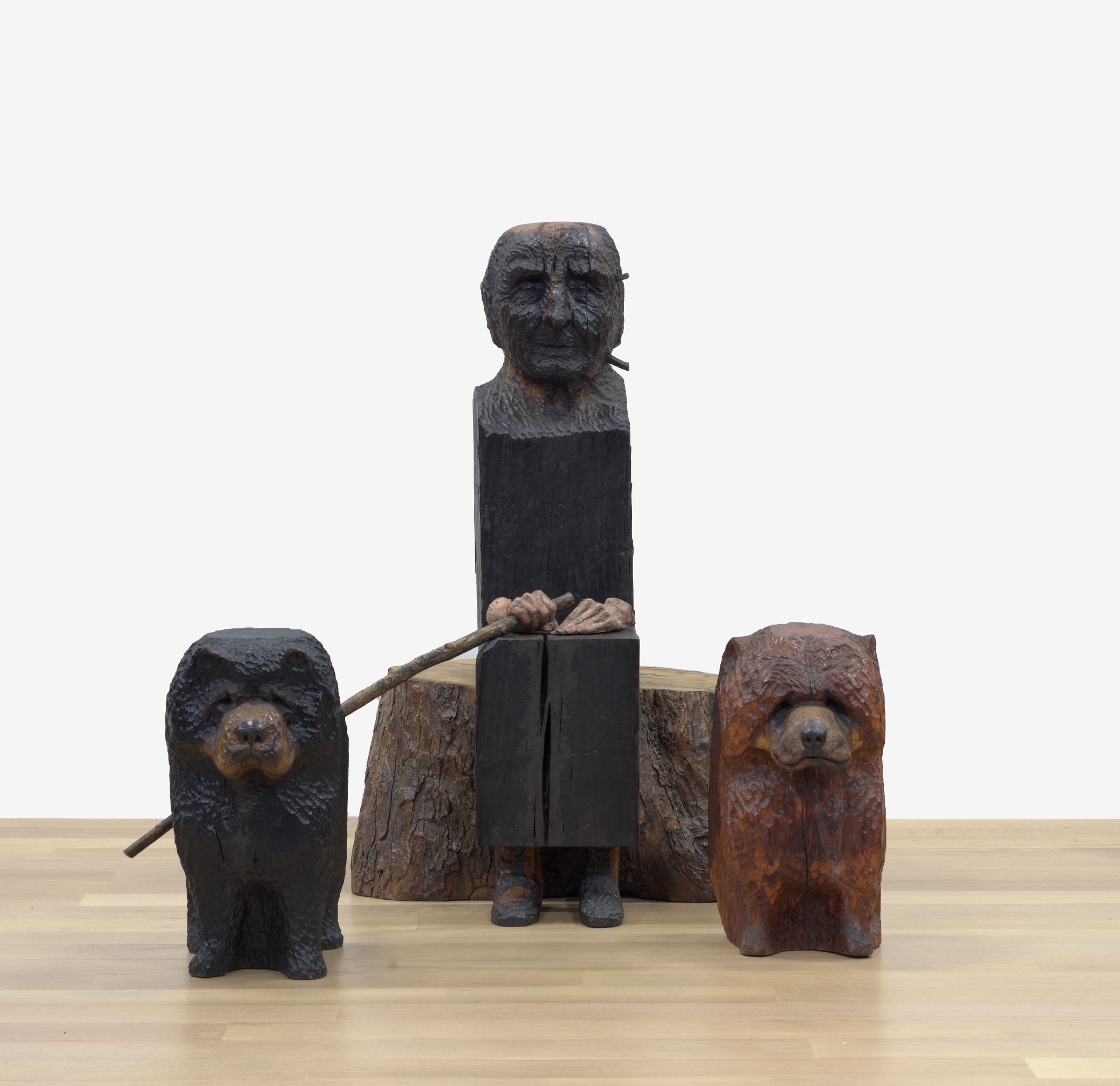 Wooden sculptures of the artist Georgia O'Keeffe and two large dogs