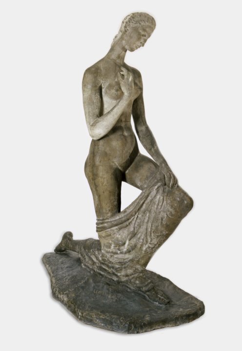 Statue of a woman kneeling on one knee with her hand placed over her heart 