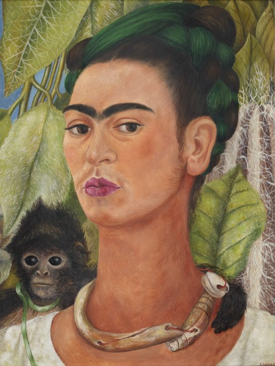 Self portrait of Frida Kahlo wearing a white shirt in front of green leaves with a monkey behind her shoulder holding on around her neck 
