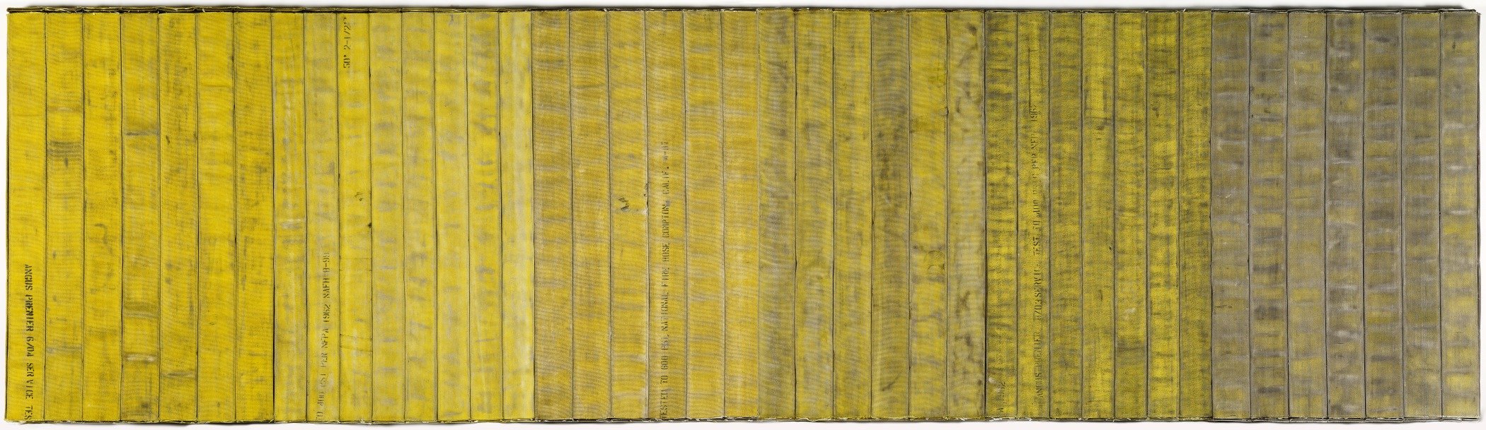 Long horizontal panel of firehoses sewed together with the a gradient of the yellow being brighter/cleaner from the left that slowly fades into darker/more weathered tones towards the right 