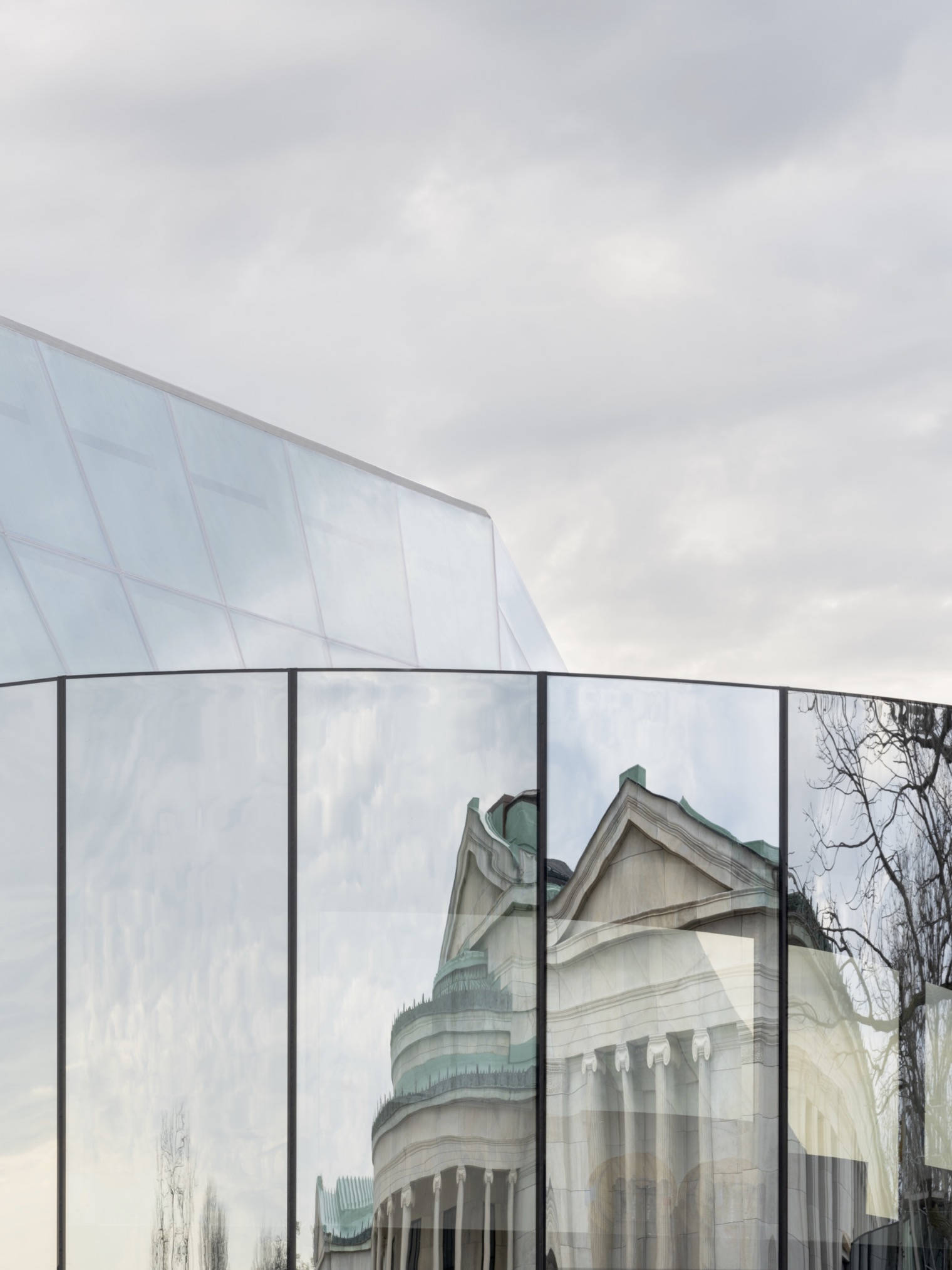 A glass bridge reflecting a museum