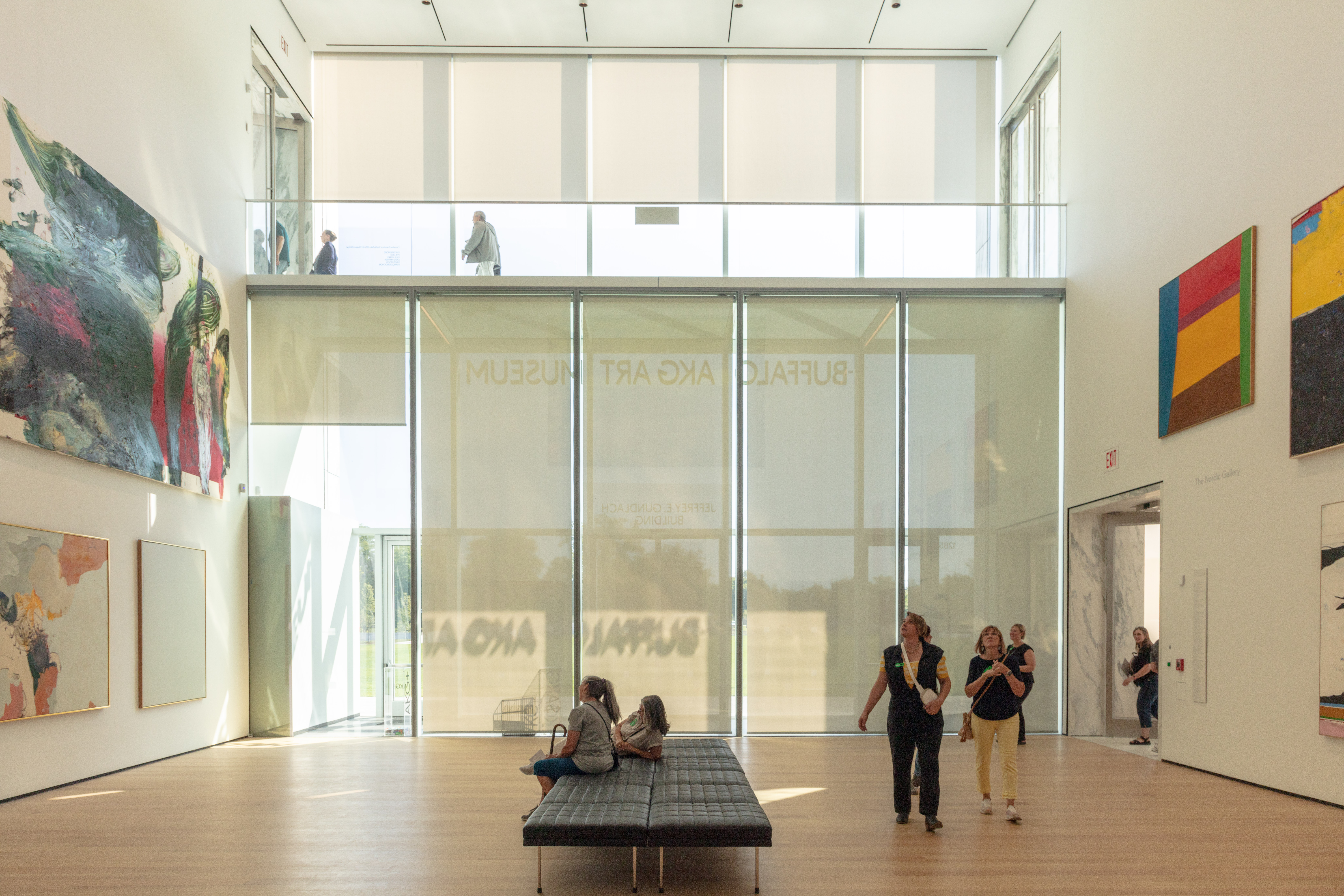 A large gallery with floor to ceiling windows