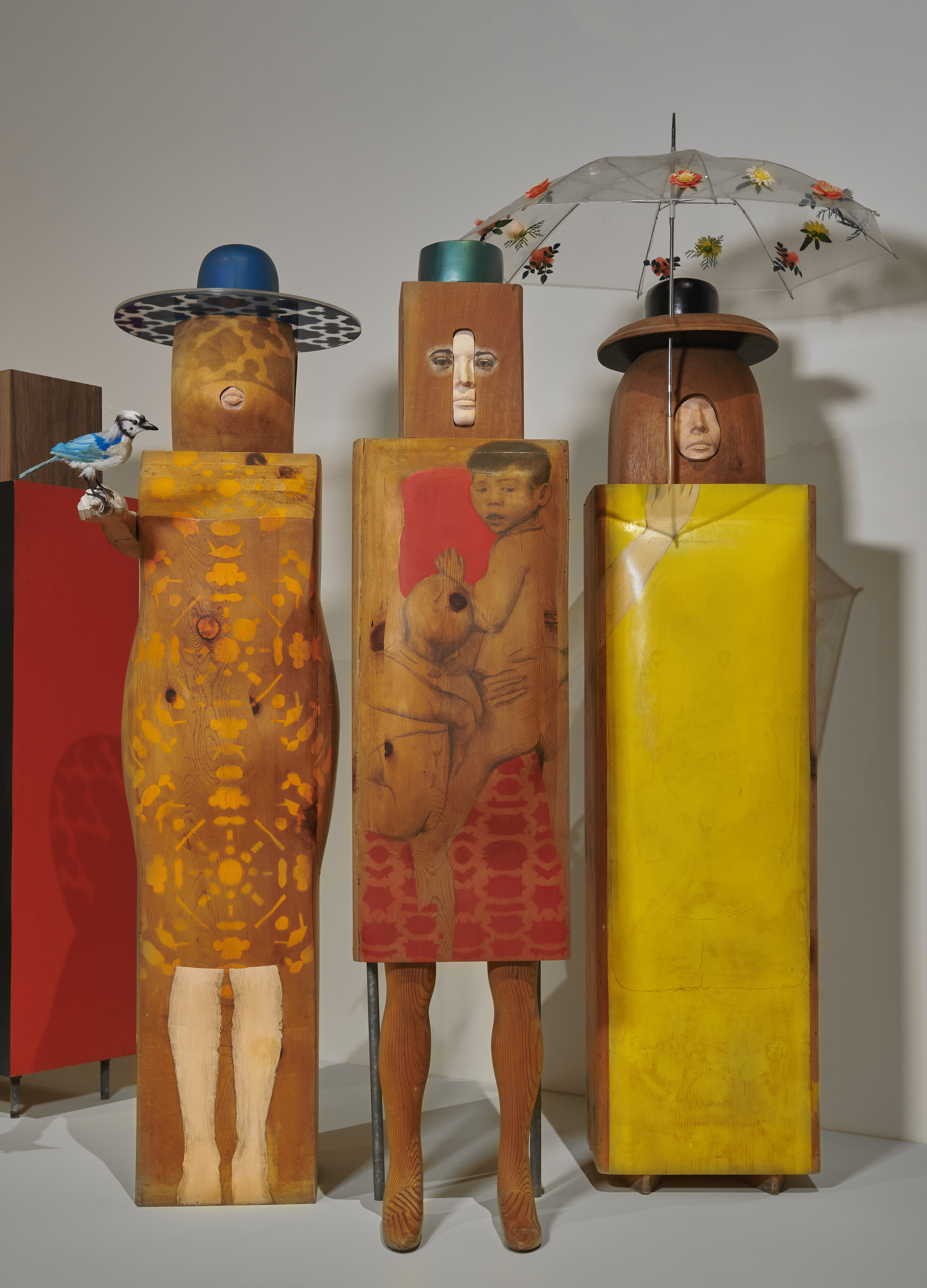 Pop Art wooden statues of three women wearing large decorative hats