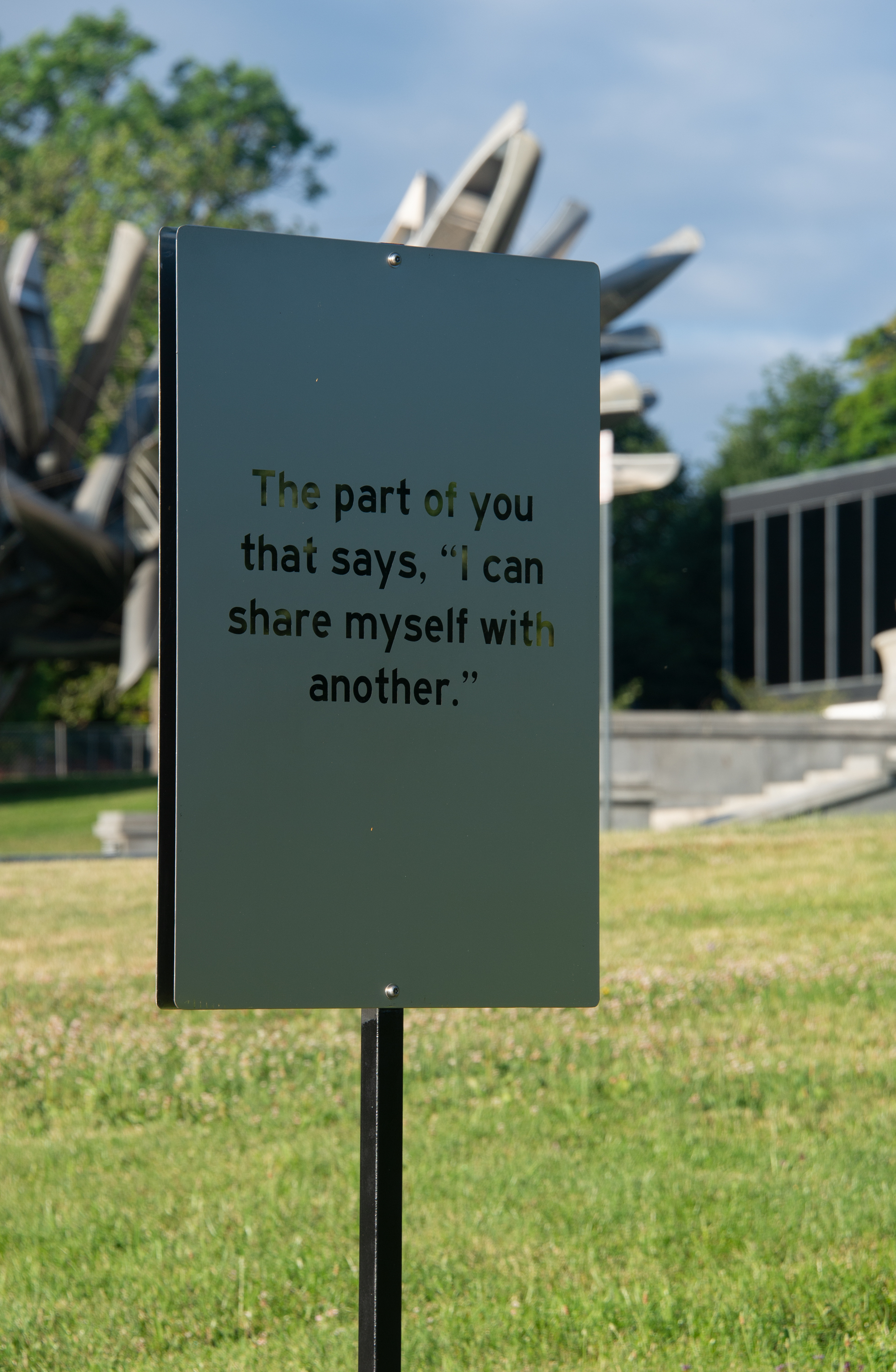 A frosted sign that reads "The part of you that says, '“I can share myself with another.”'