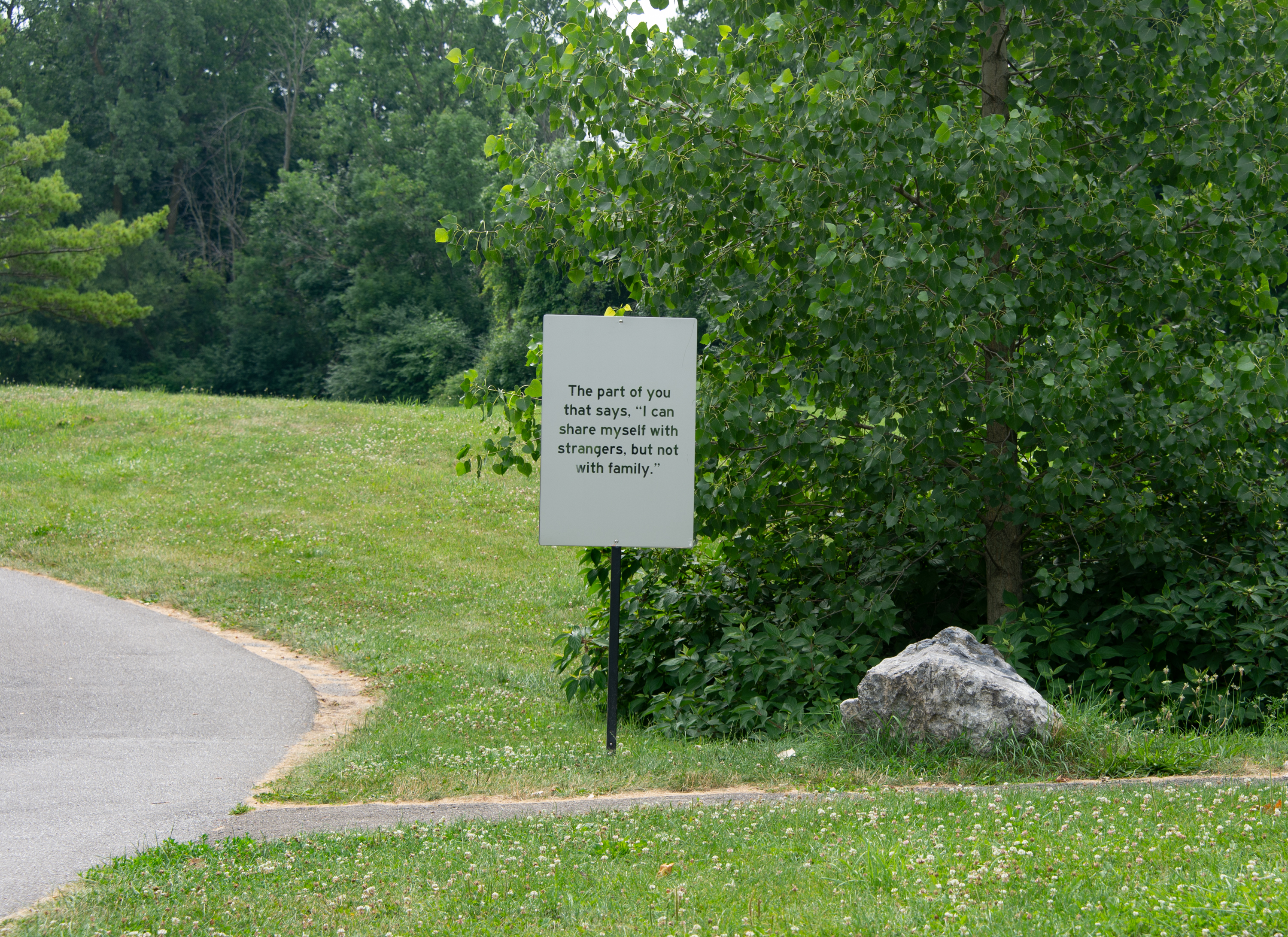 A sign that reads "The part of you that says “I can share myself with strangers, but not with family.”  