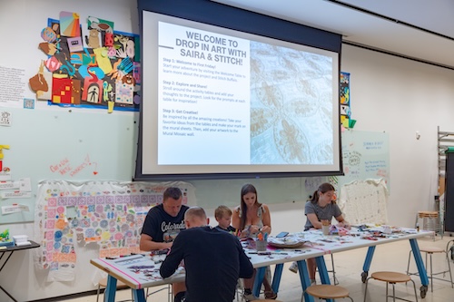 Students working at a table in an art studio