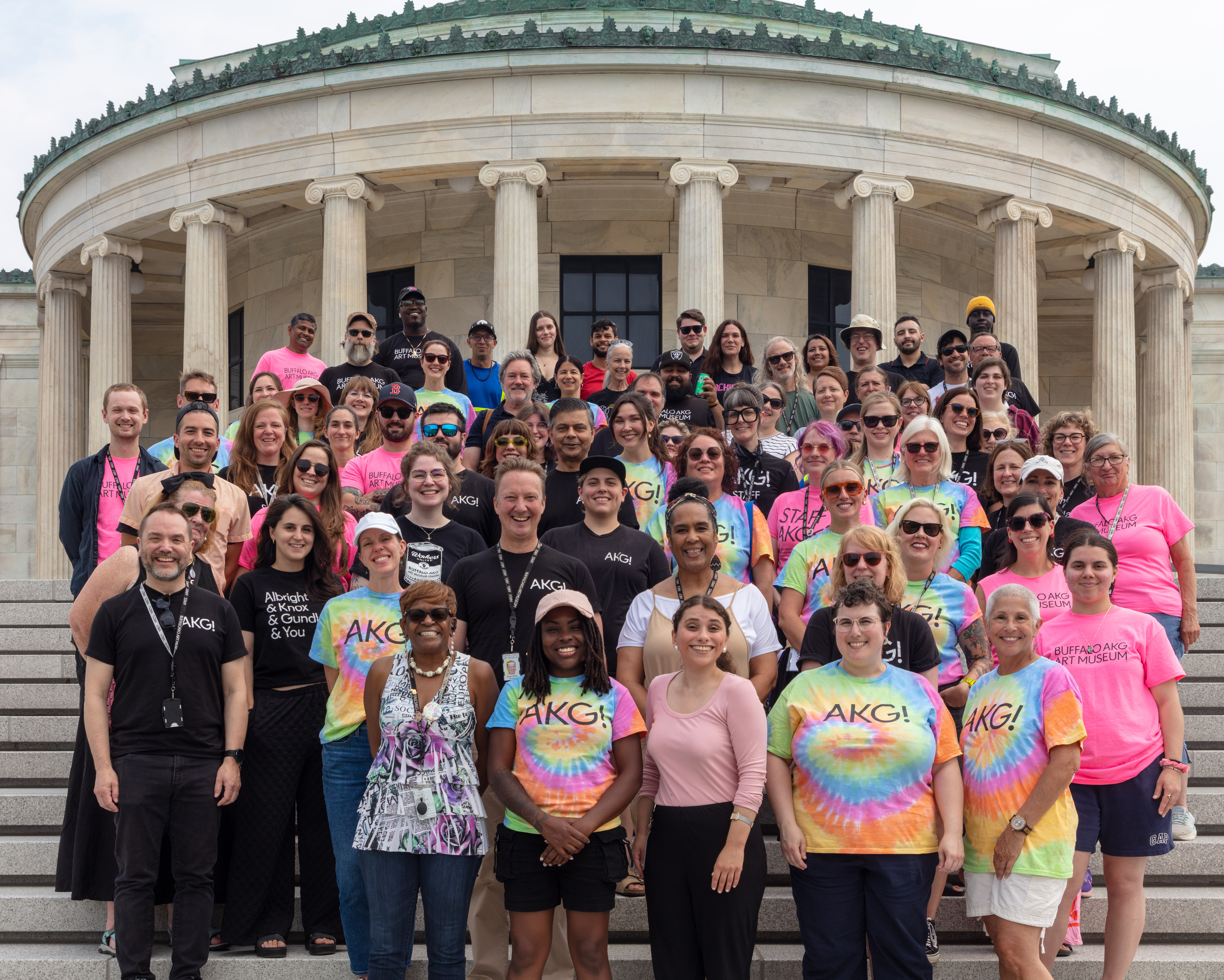 Group photo of people in pink and rainbow shirts