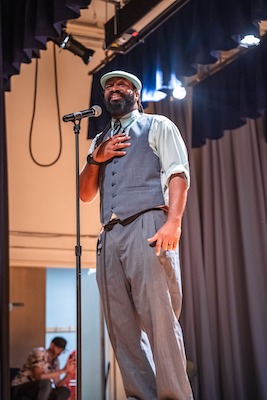 A man on a stage talking into a microphone
