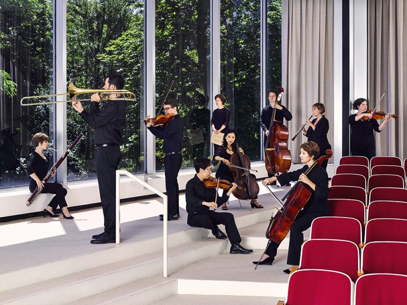 Buffalo Chamber Players posing with their instruments in the museum's Auditorium