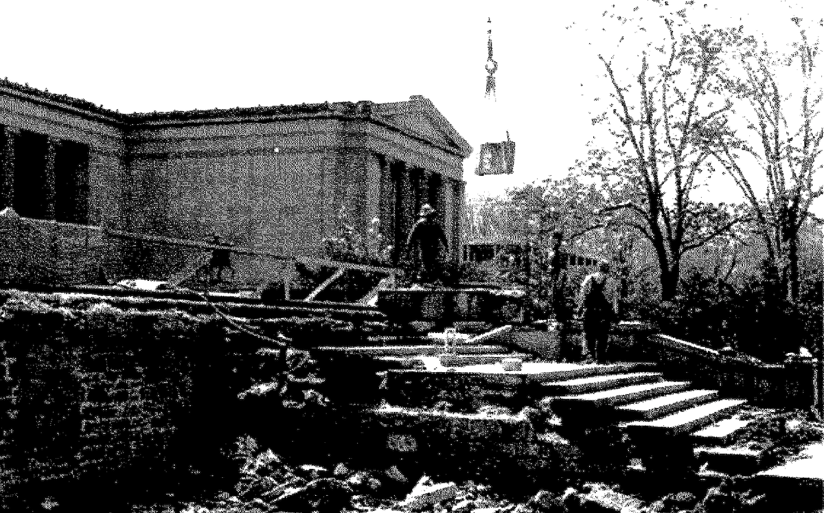 Black and white photograph of demolition of a marble stairway