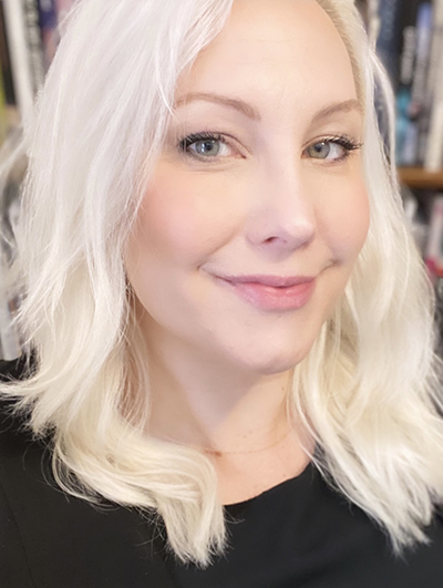 Close up of the face of a woman with long platinum blonde hair