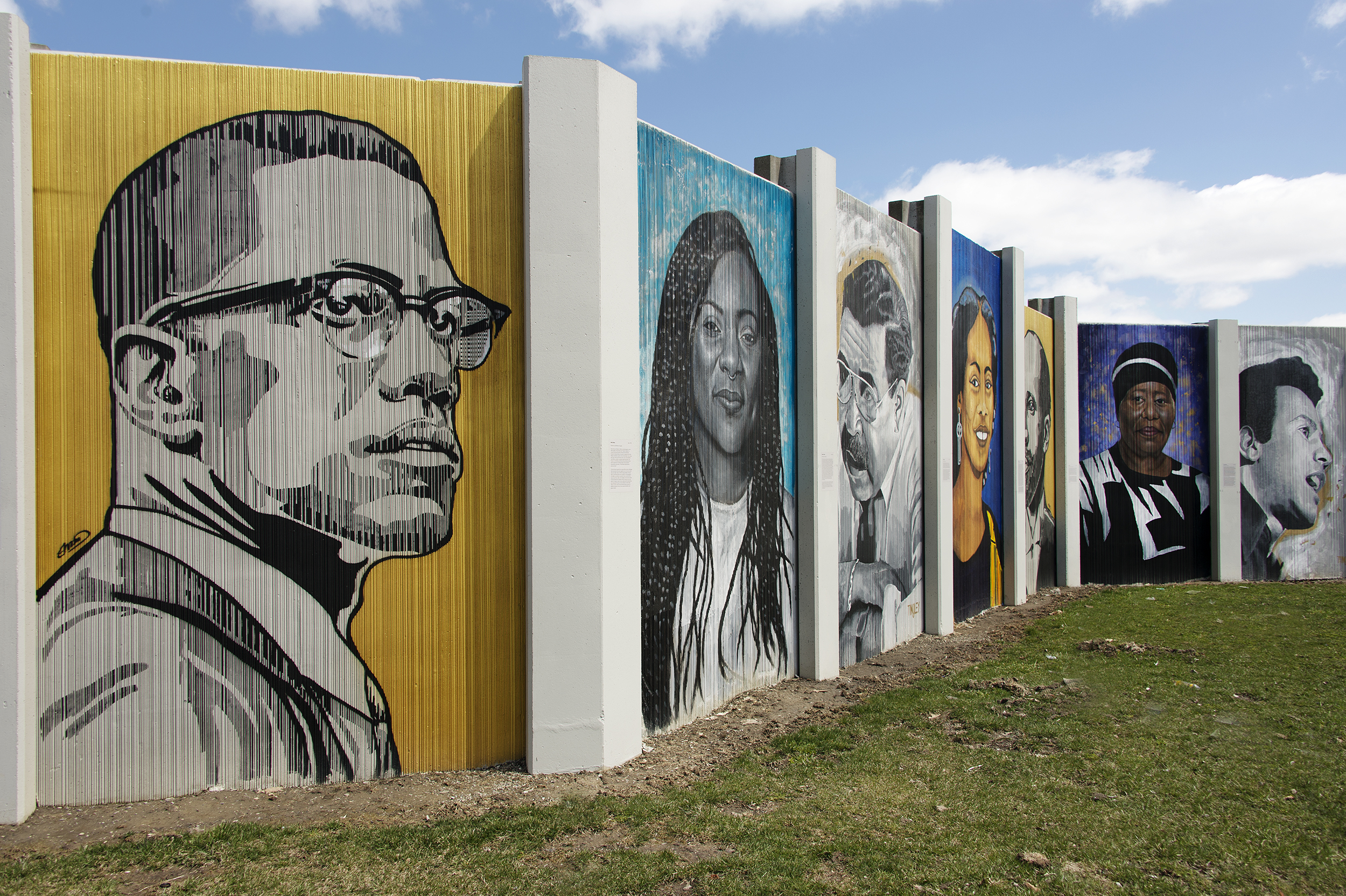 A view of The Freedom Wall featuring, from left to right, Malcolm X, Alicia Garza, George K. Arthur, W. E. B. DuBois, Eva Doyle, and Huey P. Newton