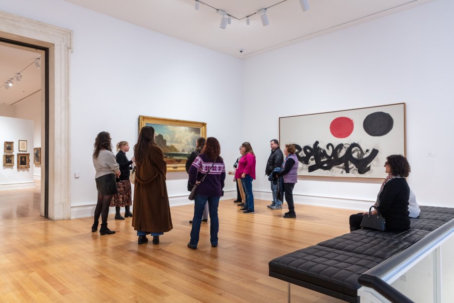 A group of adults on a tour in an art gallery