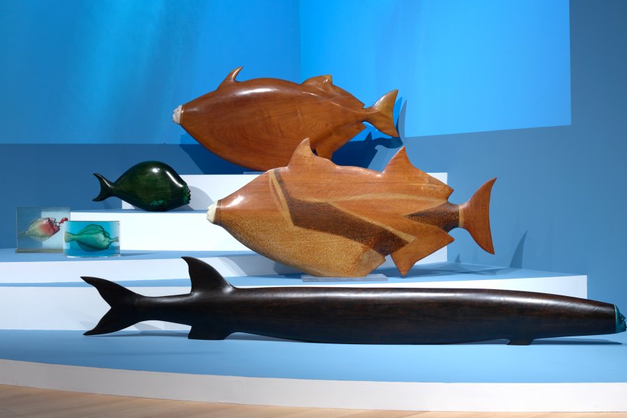 Wooden sculptures of fish with human faces