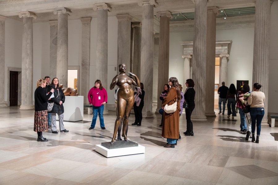 A group of individuals on a tour in an art gallery