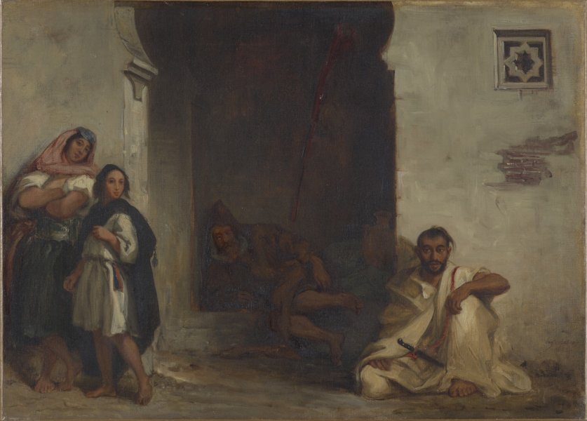 Four barefoot figures populate this scene of a Moroccan street at midday. On the left, a woman and a young adult stand outside a darkened doorway; an older man sleeps hidden in its shadows. The woman wears a knee-length garment belted with a decorative sash and a scarf covers her hair. The young adult wears a knee-length tunic and a voluminous shawl. A white robed man holding a knife sits on the other side of the doorway.