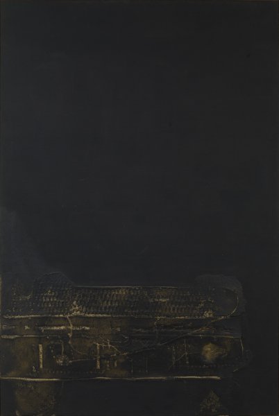 The majority of this portrait-oriented canvas is an uninterrupted expanse of matte black. In the bottom third of the canvas, a mixed-media element in shallow relief extends from the left edge. This element appears to have a bumpy, ridged texture in places. There are roughly defined and thinly applied patches of dark yellow-brown paint that appear to overlay the relief element.