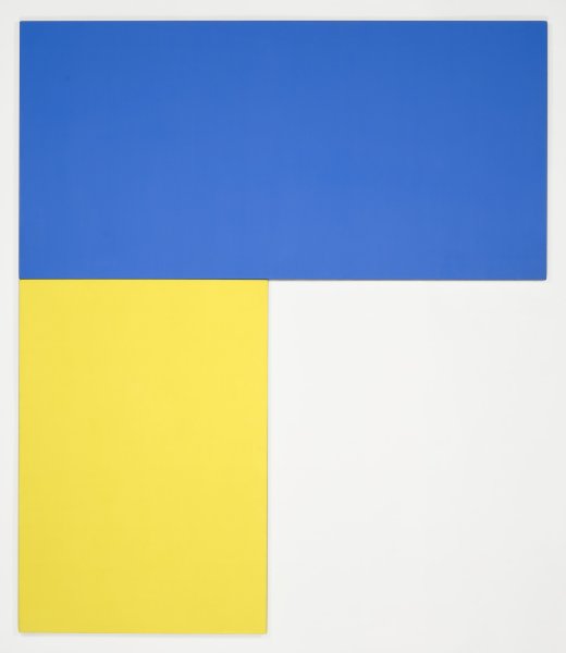 This artwork is made up of two separate, rectangular panels installed adjacent to one another at a right angle. The top panel is horizontally oriented and a solid dark blue color. Aligned underneath the left side of this panel is a second, smaller panel that is vertically oriented and a solid yellow color.