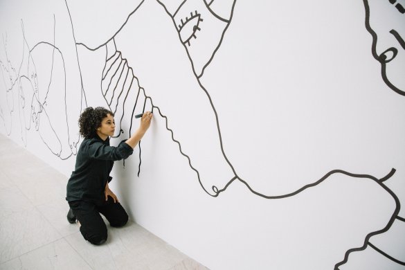 Shantell Martin working on a mural in the Albright-Knox's Sculpture Court