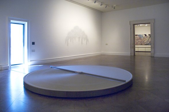 Installation view of REMIX: Recent Acquisitions, featuring Mona Hatoum's + and -, 1994–2004, in the foreground, and Teresita Fernández's Mirror Canopy, 2007, on the wall