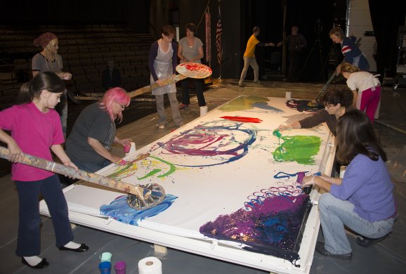 Participants help create one of Charles Clough's Arena Paintings at Hilbert College