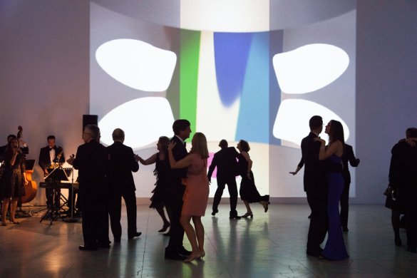 Guests dance in the Sculpture Court in front of Jeremy Blake’s Mod Lang, 2001