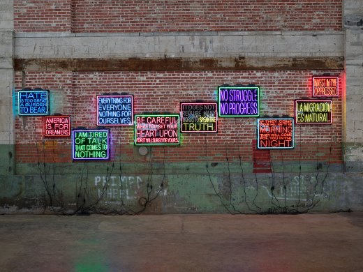 Ten neon signs on a brick wall