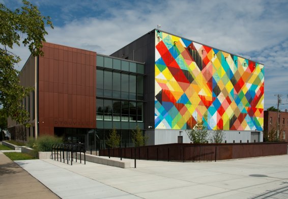 A colorful mural on the side of a large building