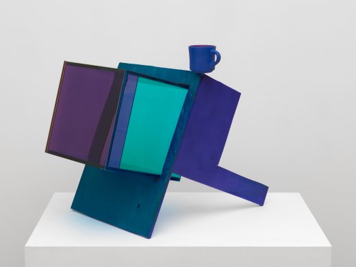 A sculpture made of wood and plexiglass in hudes of blue, teal, and purple