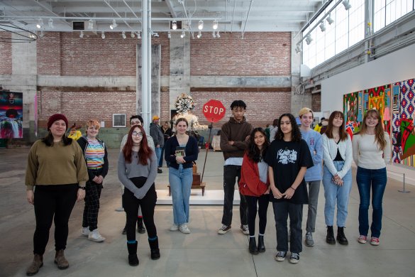 A group of people standing in a large exhibition space