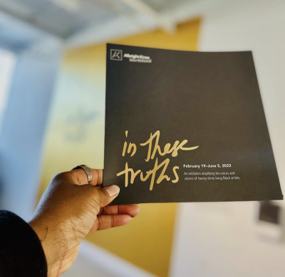 Aitina Fareed-Cooke holds the exhibition guide to In These Truths