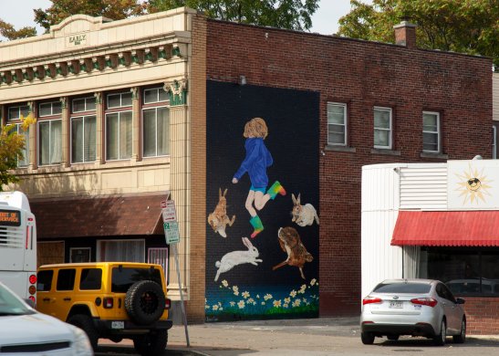 Mural on a wall nestled into a brick wall