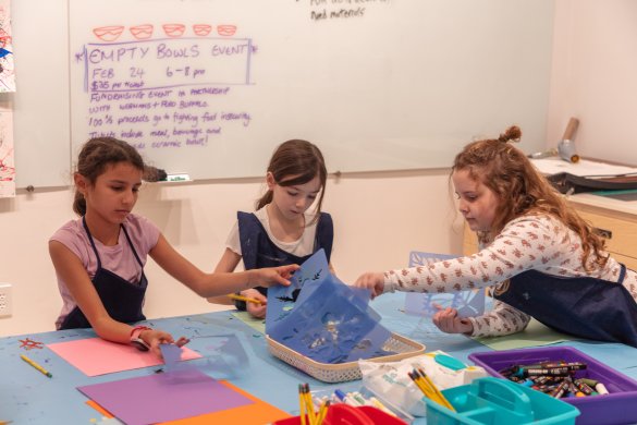 Three girls working on an art project