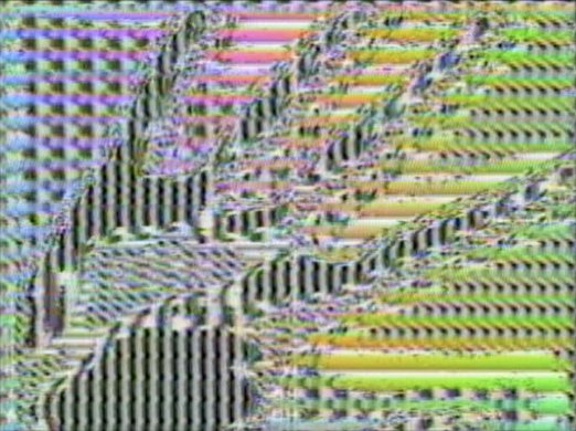A psychedelic, electronically processed image that shows the outline of a hand filling the frame.
