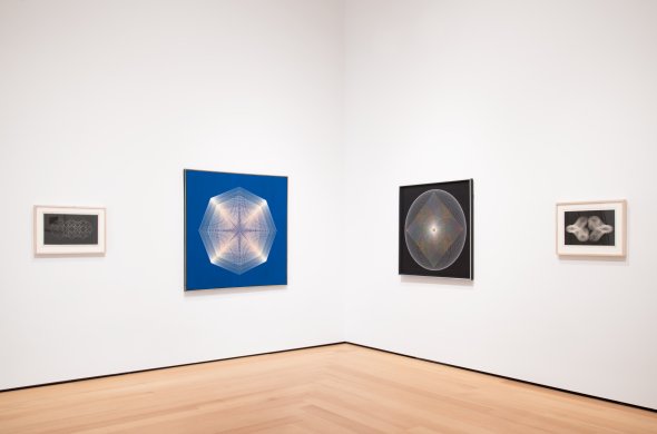 Installation view of Op art works on white gallery walls