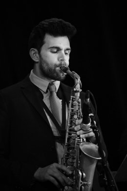 Black and white photo of a person playing the saxophone