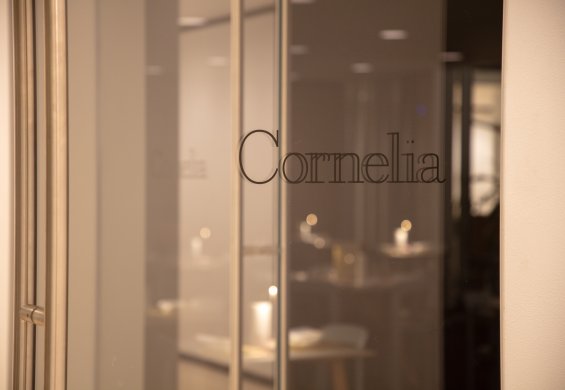 A view of a glass door with Cornelia printed on it