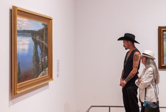 Visitors looking at an artwork