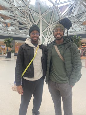 Two people standing and smiling