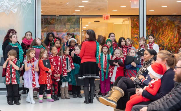 A children's choir performing at the museum