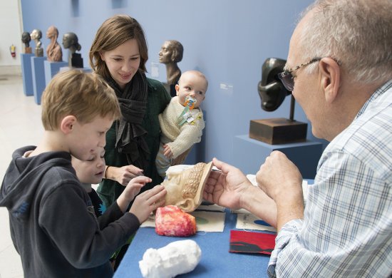 A family interacts with materials on the Albright-Knox's ArtCart