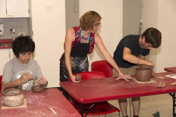 Teens sculpting with clay in the classroom