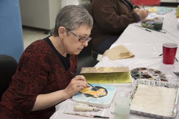 A woman painting in the classroom