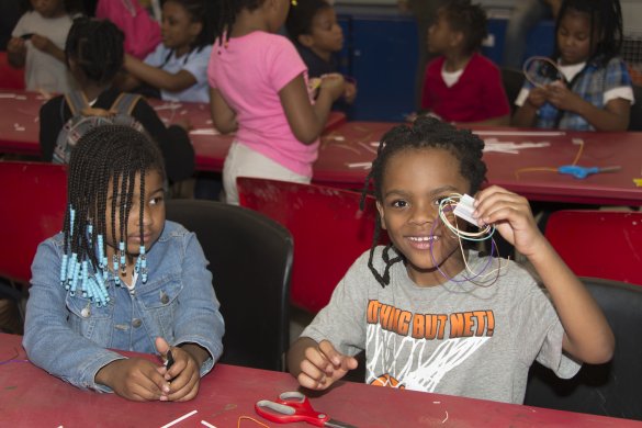 Two young girls making art in the classroom