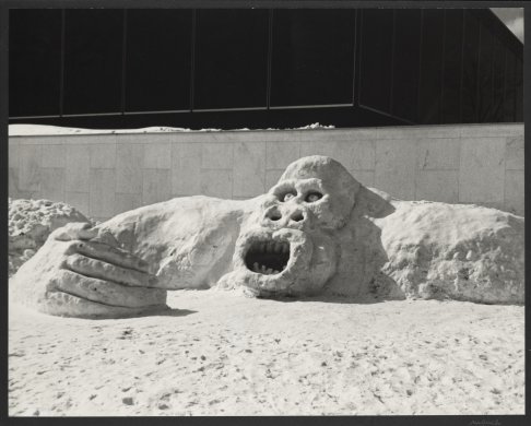 Snow sculpture of a monster with wide eyes and open mouth