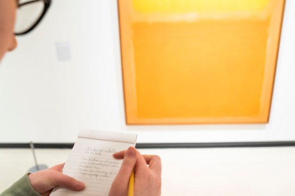 A poet from Just Buffalo Writing Center creates a made-to-order poem in front of Mark Rothko's Orange and Yellow, 1956