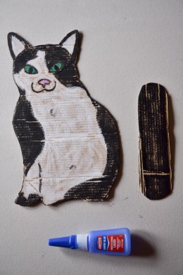 Black and white cat made on cardboard
