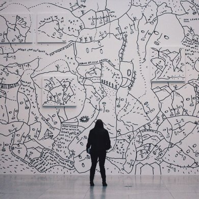 Silhouette of a person looking at Shantell Martin's mural