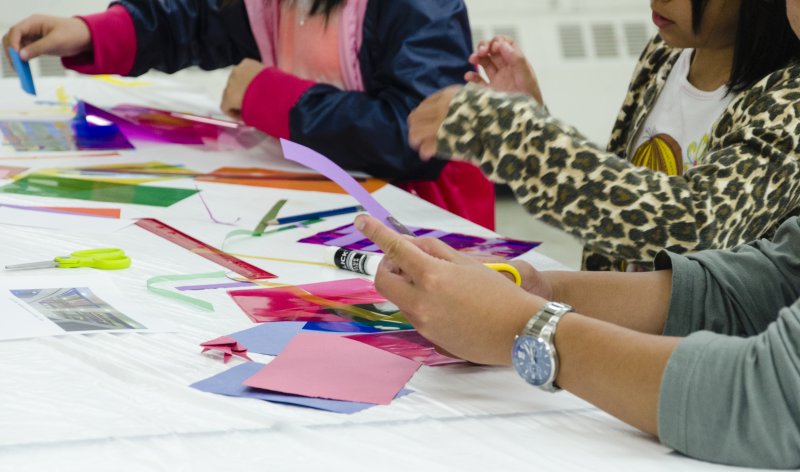 Hands making art in the classroom