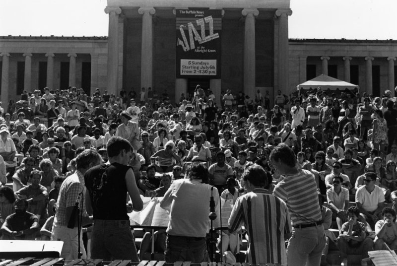A black and white photo of guests watching a jazz concert outside on the museum's Delaware Stairs